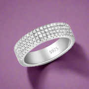 A sterling silver ring with a sparkling eternity design studded with cubic zirconias, with the ring size 'S' inscribed on the band.